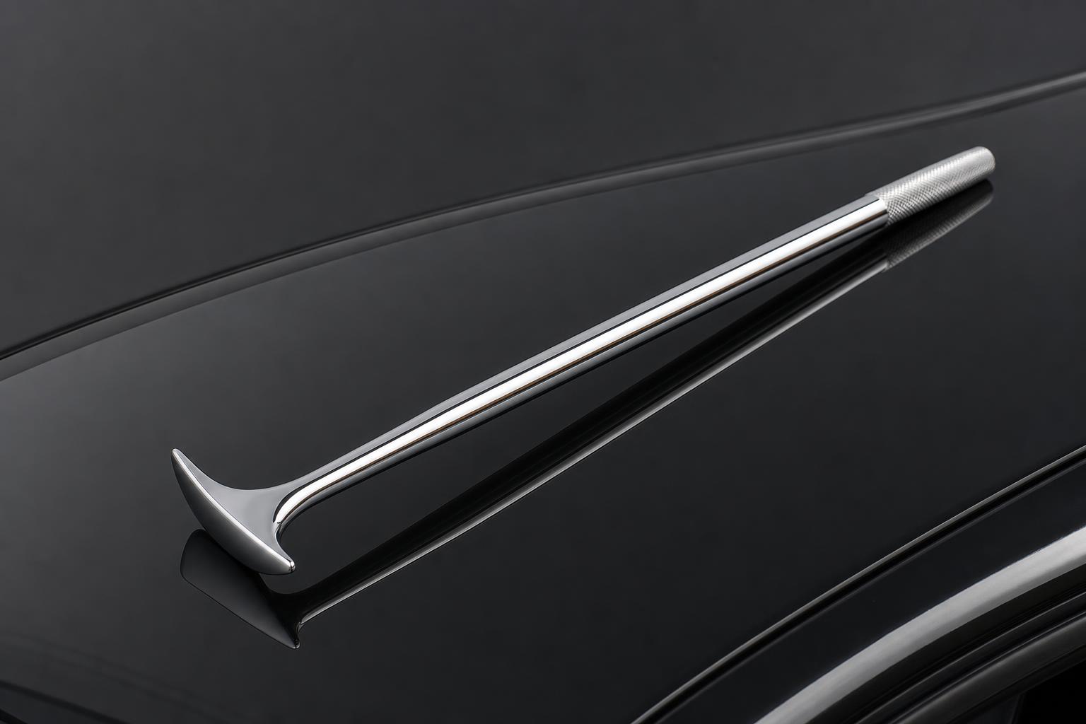 A paintless dent repair tool reshaping a car panel from behind